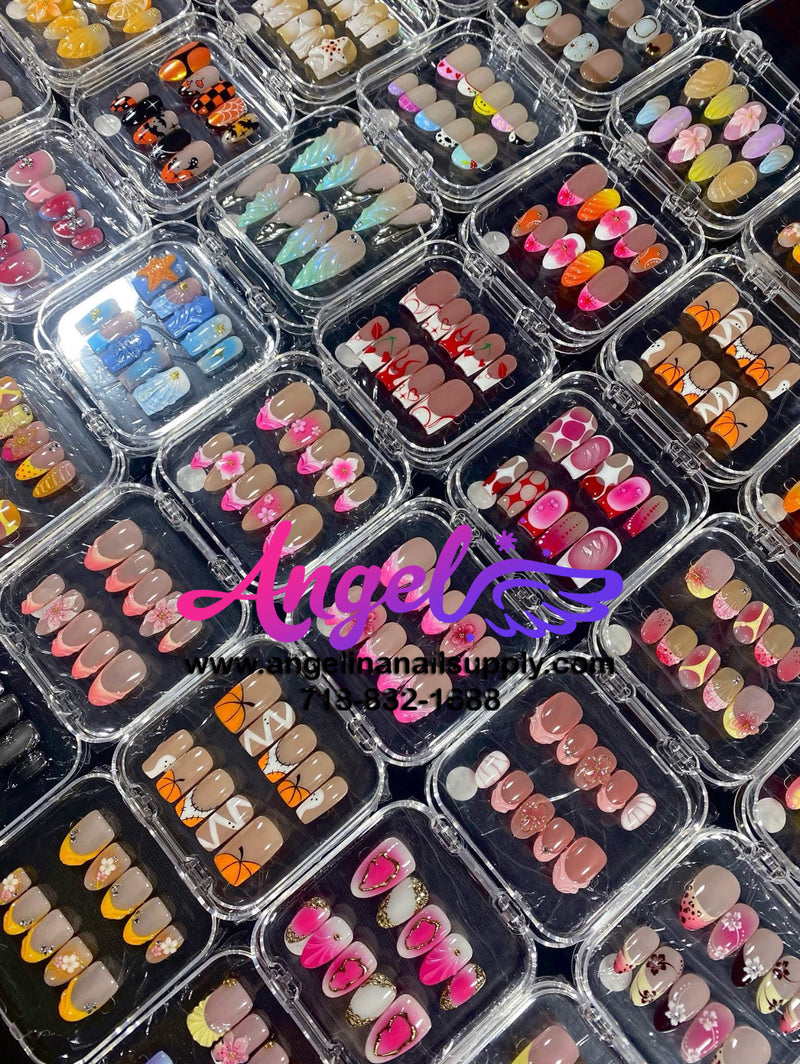Display of various nail art designs in small plastic cases with 'Angelina Manicure' branding.